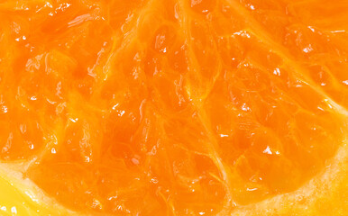 Fototapeta premium Macro Close-Up of Fresh Orange Pulp Texture,Detailed macro shot showing the juicy texture, vesicles, and vibrant orange color of a fresh ripe orange segment slice, perfect for healthy food.