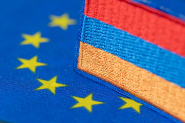 Business concept close-up of European Union and Armenia flag elements symbolizing EU accession and...