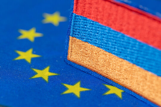 Business concept close-up of European Union and Armenia flag elements symbolizing EU accession and integration