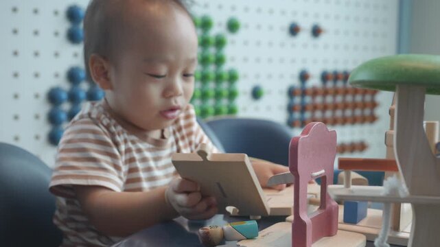 A young child explores creativity and fun with a variety of colorful wooden toys, fostering imagination and skill development through play.