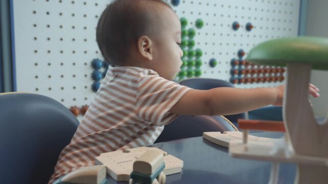A charming scene of a young child engaged in play, exploring a colorful educational space with interactive toys. This environment encourages creativity and imagination while fostering early learning.