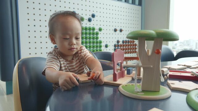 A child interacts with colorful wooden educational toys, fostering creativity and cognitive skills in a playful environment.
