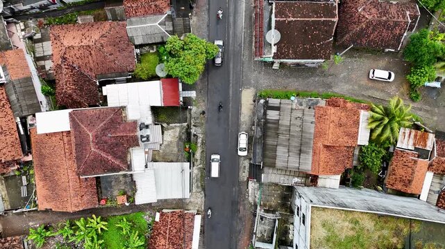 Aerial view of Lio citarik with houses, a road with vehicles, and lush greenery in Kecamatan Pelabuhanratu, Jawa Barat, Indonesia.