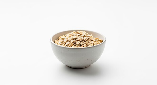 Bowl of rolled oats, dry healthy breakfast cereal, pile of uncooked oatmeal flakes, wholesome grain, energy food, isolated on white background, simple nutrition.