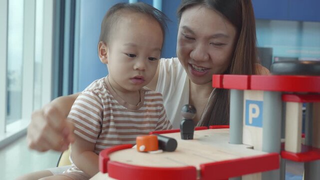 A joyful scene of a child and a parent interacting with a toy garage set, promoting bonding and creativity. The bright environment enhances the playful atmosphere, encouraging imaginative play and lea
