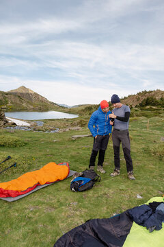UGC Men reviewing GoPro footage at alpine camp in Pyrenees