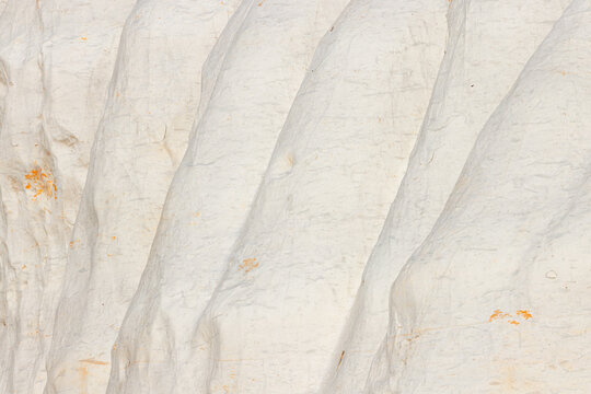 View of the white chalky rock formations with vertical ridges at Tuzbair in Mangystau District, Mangystau Region, Kazakhstan.