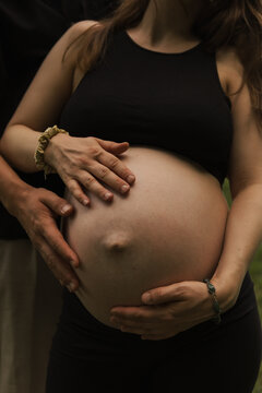 pregnant woman holding her belly