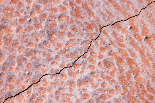 View of Kyzyl Kup, or Tiramisu, featuring layered geological formations with textured patterns and a crack across the arid landscape in Karakiya District, Mangystau Region, Kazakhstan.