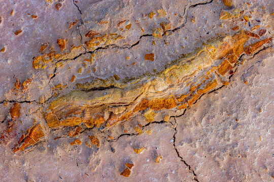 View of Kyzyl Kup, also known as Tiramisu, featuring unique layered rock formations and cracked desert soil in Karakiya District, Mangystau Region, Kazakhstan.