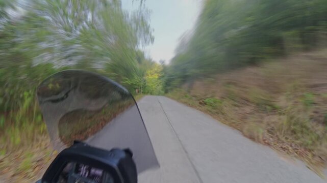 Time Laps Scooter Dashboard and Windshield Lead a Fast Ride Along a Narrow Road Through Lush Green Vegetation, Dynamic Motion Blur Supports Travel and Adventure Vertical video.