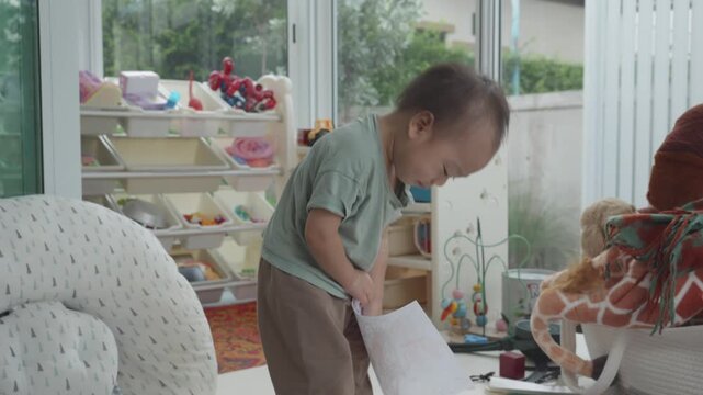 A young child intently colors on a sheet of paper, showcasing their creativity and focus. The environment is bright and playful, reflecting a space designed for learning and imaginative play.