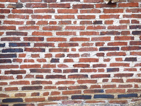 Rustic red brick wall texture background with thick mortar lines