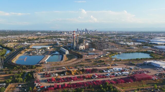 Aerial view of Cherokee Generating Station with cooling ponds and industrial facilities near the Denver skyline in Denver, Colorado, United States.