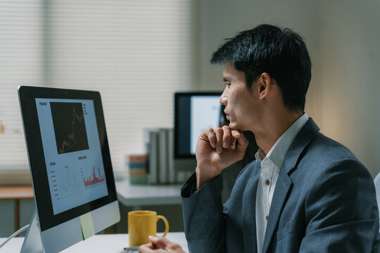 Young investor analyzing financial market data on computer