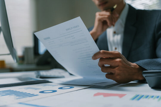 Businessman analyzing financial data and cash flow statement