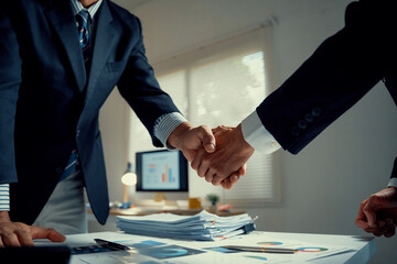 Fototapeta na wymiar Businessmen shaking hands making agreement in office