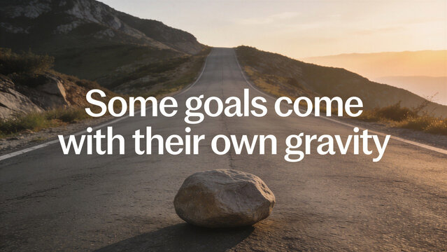 Large stone on an uphill road at sunset under white text quote "Some goals come with their own gravity". Motivational quotes on overcoming obstacles and ambition.