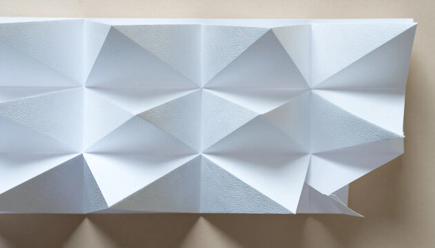 A geometric origami paper sculpture folded into intricate triangular patterns against a neutral background.