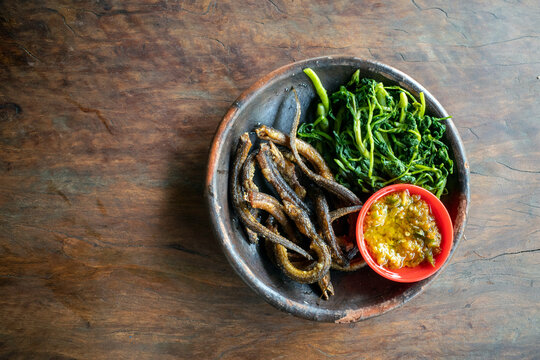 Indonesian Deep Fried Eel Served with Boiled Water Spinach and Spicy Sambal