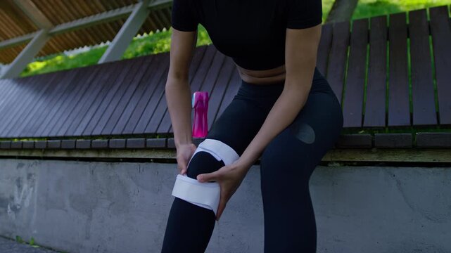 Athlete Securing Knee Support After Exercise
