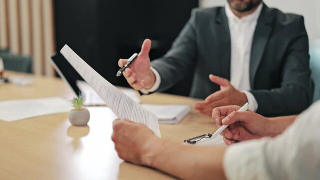 Professionals engage in focused business discussion, reviewing important documents and taking notes. Collaboration and strategic planning unfold within the meeting room