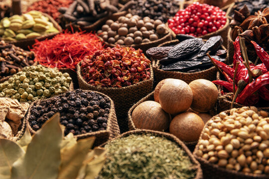collection of seasonings and herbs in cloth bags, colorful spices background