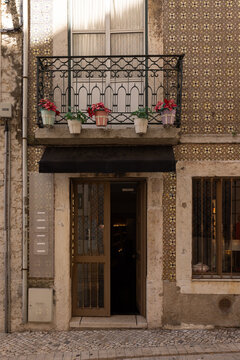 traditional storefront in Portugal underneath residential apartment with balcony