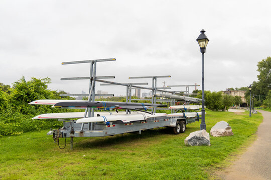 View of a rowing boat trailer parked on a grassy field with a lamp post and path in Henrico, Virginia, United States.