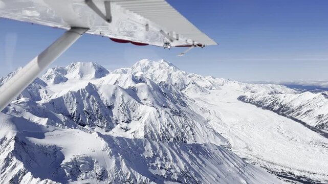 Aerial view of Denali National Park and Preserve with snow-covered mountain peaks and glaciers in Alaska, United States.