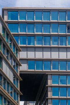 View of the modern glass facade of a contemporary office building with geometric architectural lines and reflective windows in Cascais, Lisbon, Portugal.