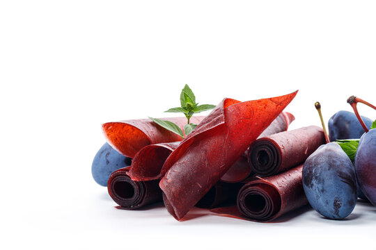 Healthy plum fruit leather with fresh plums and mint leaves