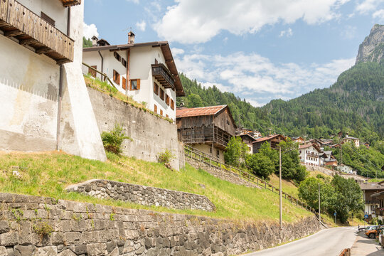 Alleghe, Italy. Traditional alpine village with historic houses, stone terraces and mountain landscape
