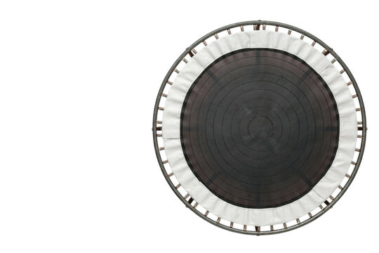 Round fitness trampoline from above, with dark jumping surface and white protective padding, isolated on white. Ideal for home workouts, exercise, and recreational bouncing