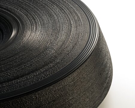 Close-up of a black, textured tire rim.