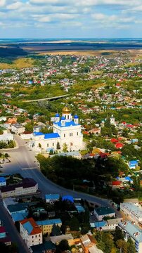 Vertical video. Yelets, Lipetsk region, Russia. Cathedral of the Ascension. Sosna river. Historic city center. Drone footage, Point of interest. Rich colors