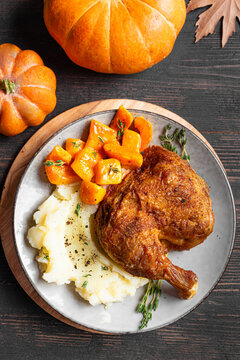 Autumn meal: chicken quarter with glazed pumpkin and mashed potato