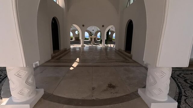 18 June 2026 Kallithea Springs, Rodos: Steady walking footage through the historic architectural complex of Kallithea Springs in Rhodes, Greece, moving between elegant columns toward the central 