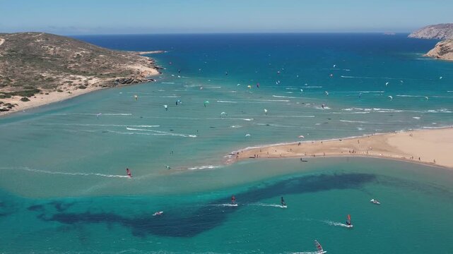 14 June 2026 Prasonisiou, Rodos: Dynamic aerial drone footage of windsurfers riding the waves at Prasonisi Beach in Rhodes, Greece. Bird's-eye view of windsurfing action, turquoise Mediterranean water