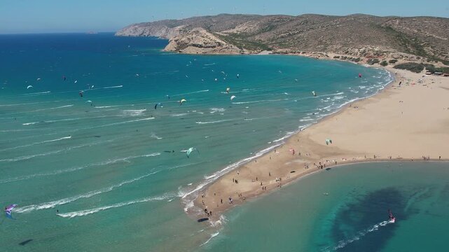 14 June 2026 Prasonisiou, Rodos: Dynamic aerial drone footage of windsurfers riding the waves at Prasonisi Beach in Rhodes, Greece. Bird's-eye view of windsurfing action, turquoise Mediterranean water