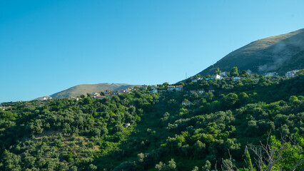 Obraz premium Hillside Village Above the Green Valley of Lukova