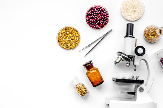 Food safety. Wheat, rice and red beans near microscope on white background top view copy space
