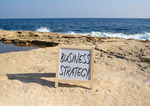 Business Strategy symbol. Blackboard with Concept words Business Strategy. Beautiful sea background. Business and Business Strategy concept. Copy space.