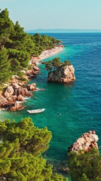 Vertical static aerial view of iconic Brela Rock in turquoise Adriatic sea Croatia