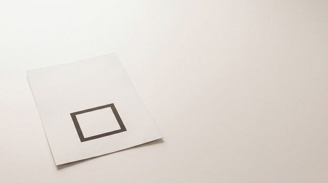 Blank paper ballot with empty black square checkbox placed on clean white surface