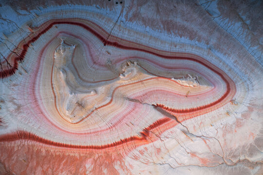 Aerial view of the colorful geological layers and unique erosion patterns of the Kyzyl Kup landmark, also known as Tiramisu, Karakiya District, Mangystau Region, Kazakhstan.
