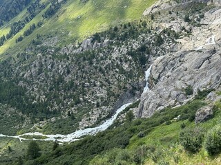 Fototapeta premium The Rhone River Falls or Waterfalls of the Rhone River (Rhonefall or Rhonefalls) below its source and under the Rhone Glacier in the Swiss Alps, Switzerland - Wasserfälle der Rhone oder Rottenfall