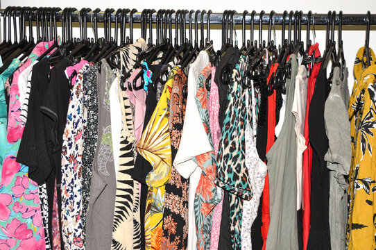 Second-hand tops and dresses in thrift store
