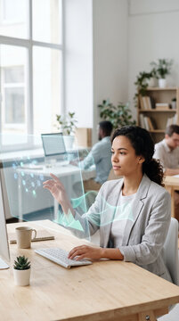 Woman analyzing glowing data hologram at office desk