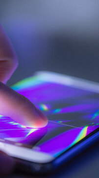Finger touching a colorful smartphone screen